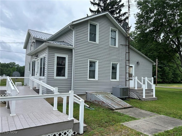 8973 Matty Rd, West Salem, OH 44287 - view of property exterior with central AC unit, a lawn, a wooden deck, and metal roof