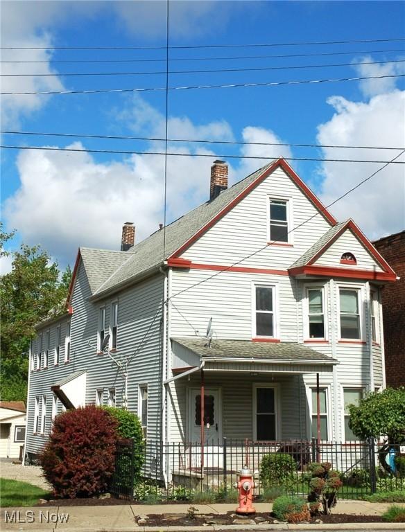 4354 E 71st St, Cleveland, OH 44105 - view of front of home featuring a chimney, a porch, and a shingled roof
