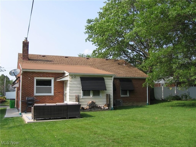 4106 Colony Rd, South Euclid, OH 44121 - rear view of property with a chimney, brick siding, an outdoor living space, a yard, and a shingled roof