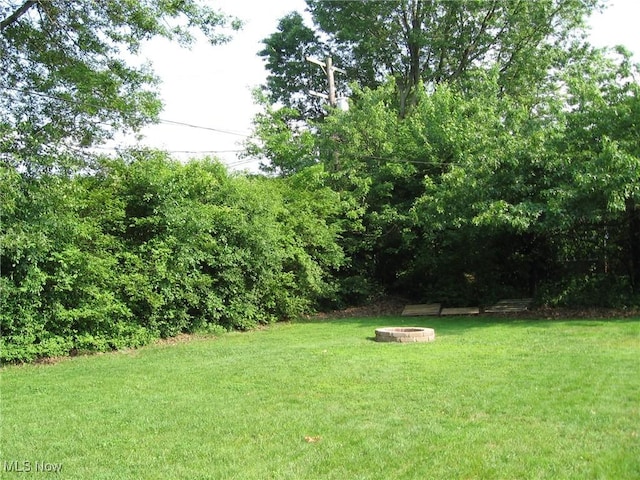 4106 Colony Rd, South Euclid, OH 44121 - view of green lawn with an outdoor fire pit