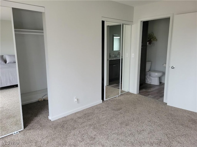 1110 By The Shores Dr, Huron, OH 44839 - unfurnished bedroom with carpet flooring, connected bathroom, a sink, and baseboards