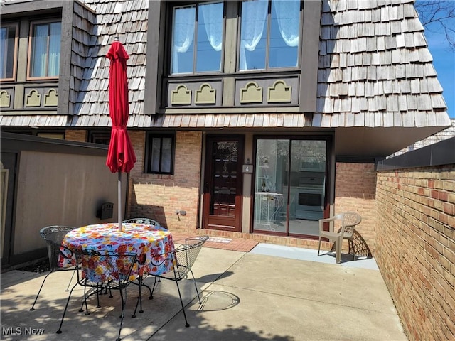 1110 By The Shores Dr, Huron, OH 44839 - property entrance featuring brick siding, mansard roof, and a patio