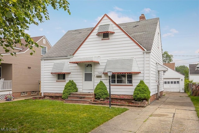 7428 Ira Ave, Brooklyn, OH 44144 - view of front of house featuring a front lawn, a shingled roof, an outbuilding, a garage, and a chimney