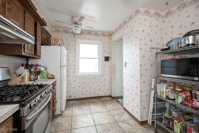 7428 Ira Ave, Brooklyn, OH 44144 - kitchen featuring stainless steel appliances, ventilation hood, wallpapered walls, ceiling fan, and light countertops