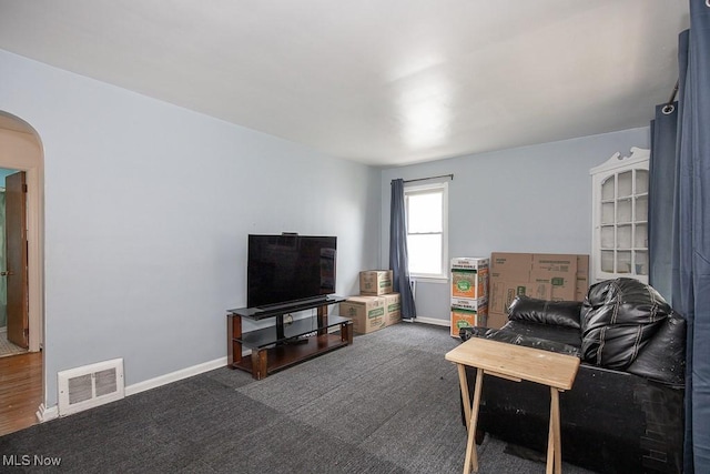 7428 Ira Ave, Brooklyn, OH 44144 - living area featuring arched walkways and dark colored carpet