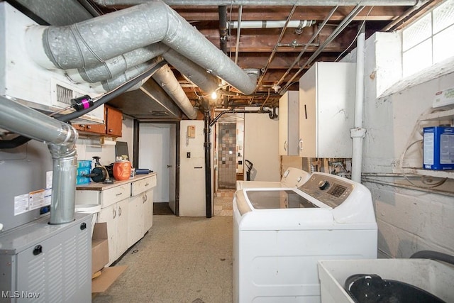 7428 Ira Ave, Brooklyn, OH 44144 - washroom with washing machine and clothes dryer, cabinet space, and light floors