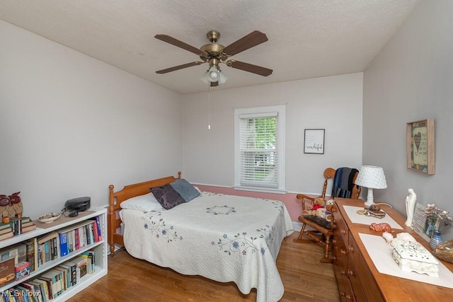 8223 Bauerdale Ave, Parma, OH 44129 - bedroom featuring wood finished floors, a ceiling fan, and baseboards