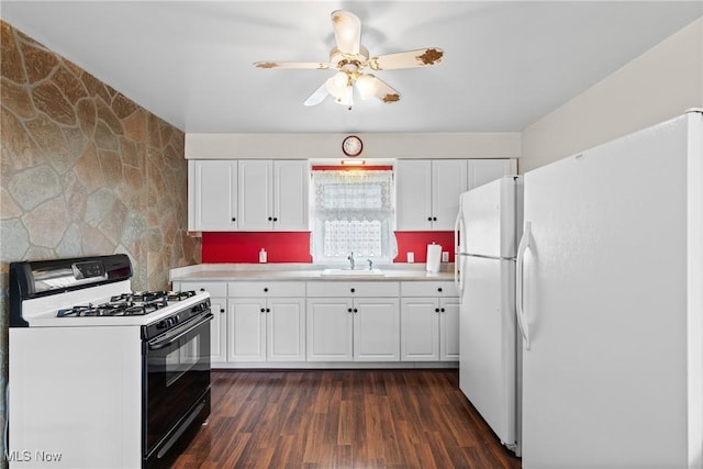 157 W 45th St, Shadyside, OH 43947 - kitchen with range with gas stovetop, freestanding refrigerator, a sink, and white cabinetry