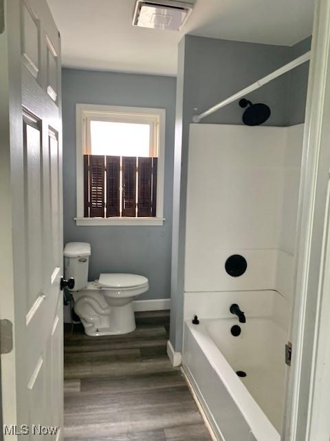 1209 N 4th St, Toronto, OH 43964 - bathroom featuring wood finished floors and tub / shower combination