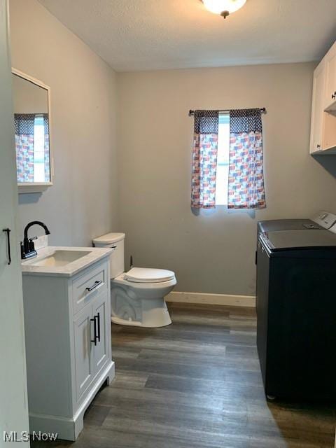 1209 N 4th St, Toronto, OH 43964 - bathroom featuring vanity, wood finished floors, and washing machine and clothes dryer