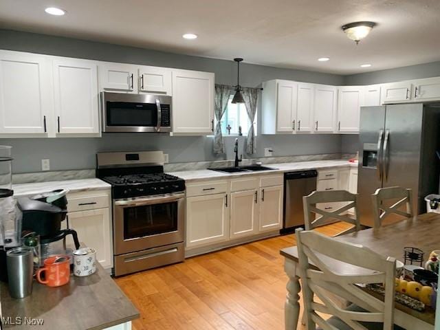 1209 N 4th St, Toronto, OH 43964 - kitchen with stainless steel appliances, decorative light fixtures, light countertops, white cabinetry, and recessed lighting