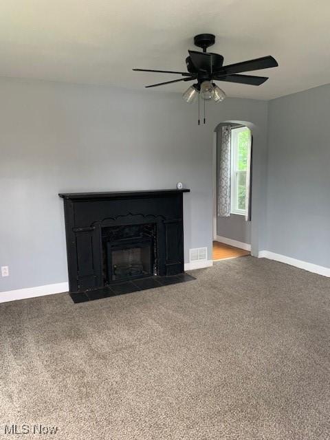 1209 N 4th St, Toronto, OH 43964 - unfurnished living room with carpet floors, ceiling fan, and a fireplace with flush hearth