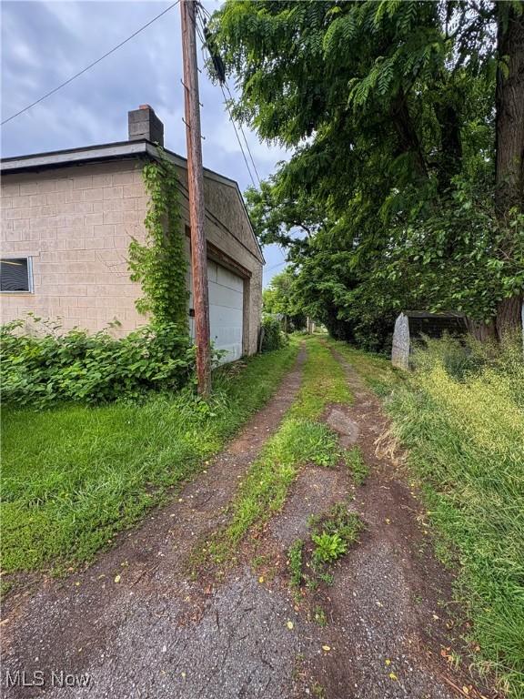 1019 Commerce St, Wellsville, OH 43968 - view of property exterior featuring a chimney