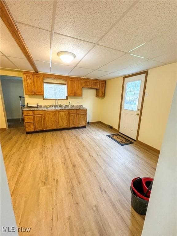 1019 Commerce St, Wellsville, OH 43968 - kitchen with brown cabinets, a drop ceiling, light wood-type flooring, and light countertops
