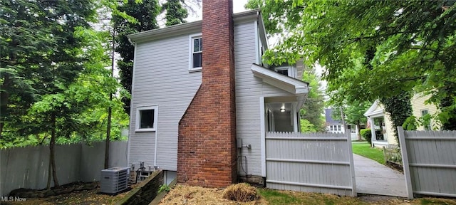 190 Columbus St, Chagrin Falls, OH 44022 - view of home's exterior with cooling unit and a chimney