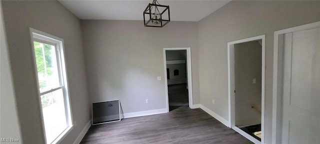 190 Columbus St, Chagrin Falls, OH 44022 - unfurnished dining area featuring dark wood finished floors, baseboards, and a chandelier