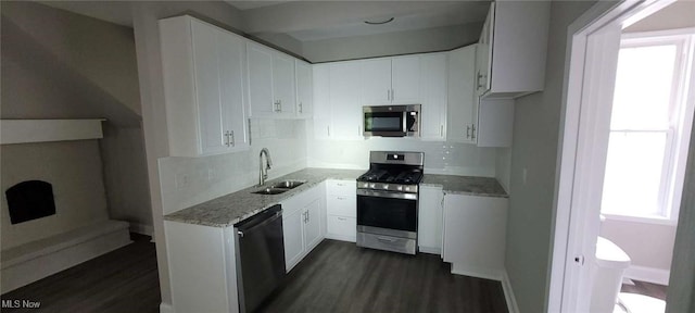 190 Columbus St, Chagrin Falls, OH 44022 - kitchen featuring appliances with stainless steel finishes, a sink, dark wood-style flooring, tasteful backsplash, and light stone countertops