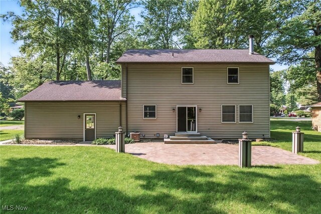 9233 Cain Dr NE, Warren, OH 44484 - back of property featuring a patio and a lawn