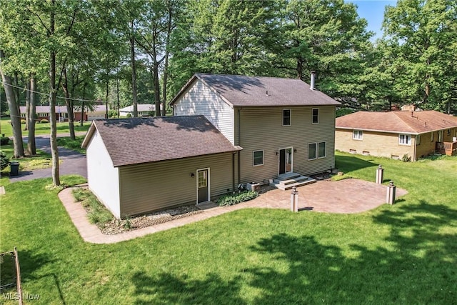 9233 Cain Dr NE, Warren, OH 44484 - rear view of house featuring a lawn, a shingled roof, a patio area, and view of scattered trees