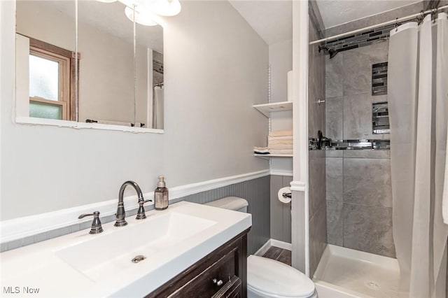 5081 Middle Ridge Rd, Perry, OH 44081 - bathroom with toilet, a shower stall, vanity, and a wainscoted wall