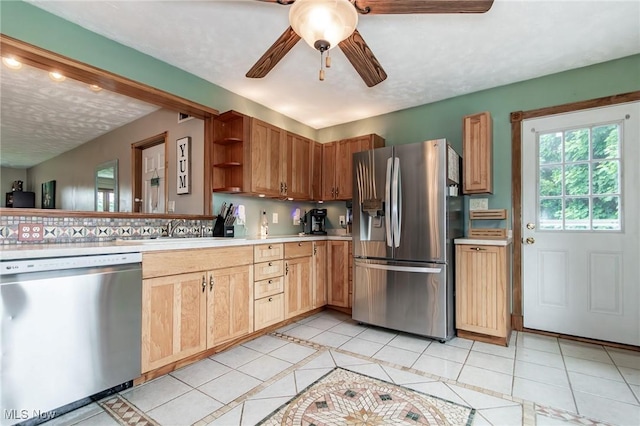 5081 Middle Ridge Rd, Perry, OH 44081 - kitchen with stainless steel appliances, light countertops, open shelves, a ceiling fan, and a sink