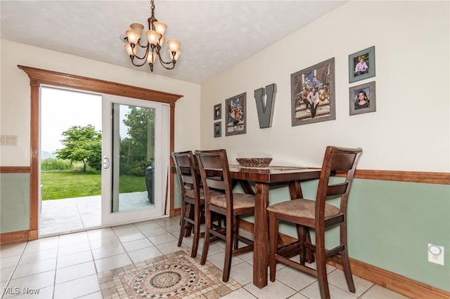 5081 Middle Ridge Rd, Perry, OH 44081 - tiled dining area with baseboards and a chandelier