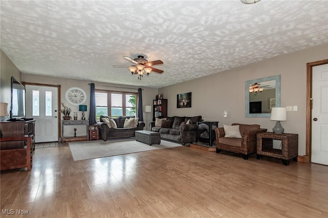 5081 Middle Ridge Rd, Perry, OH 44081 - living room featuring a ceiling fan, a textured ceiling, and wood finished floors