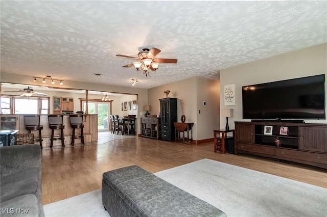 5081 Middle Ridge Rd, Perry, OH 44081 - living room featuring a ceiling fan, a textured ceiling, wood finished floors, and a chandelier