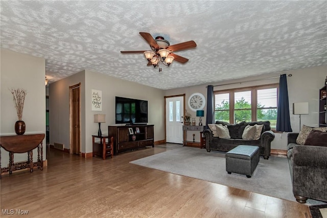 5081 Middle Ridge Rd, Perry, OH 44081 - living room featuring wood finished floors, a ceiling fan, a textured ceiling, and baseboards