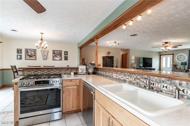5081 Middle Ridge Rd, Perry, OH 44081 - kitchen with appliances with stainless steel finishes, a sink, ceiling fan, light tile patterned floors, and light brown cabinetry