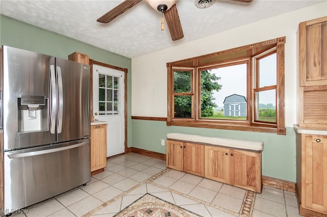 5081 Middle Ridge Rd, Perry, OH 44081 - kitchen featuring stainless steel refrigerator with ice dispenser, baseboards, a ceiling fan, and healthy amount of natural light