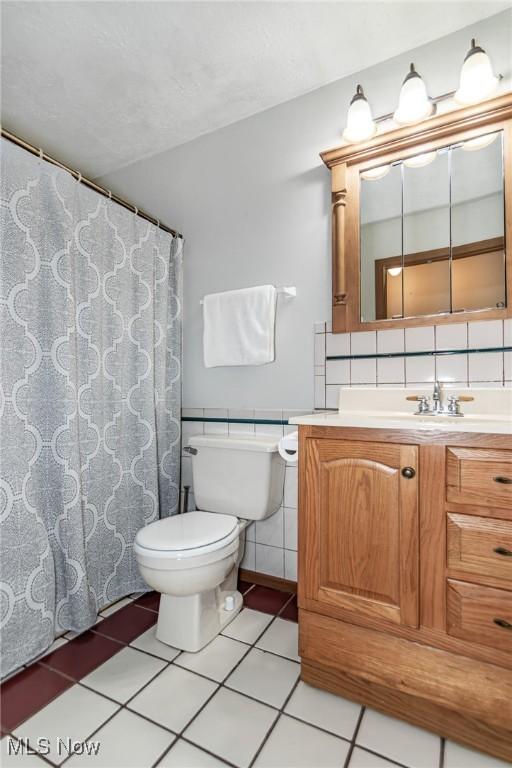 5081 Middle Ridge Rd, Perry, OH 44081 - full bath featuring toilet, vanity, and tile patterned floors