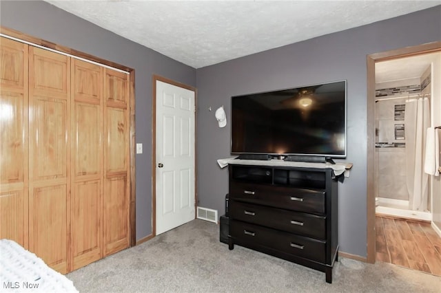 5081 Middle Ridge Rd, Perry, OH 44081 - bedroom featuring baseboards, light carpet, a closet, and a textured ceiling