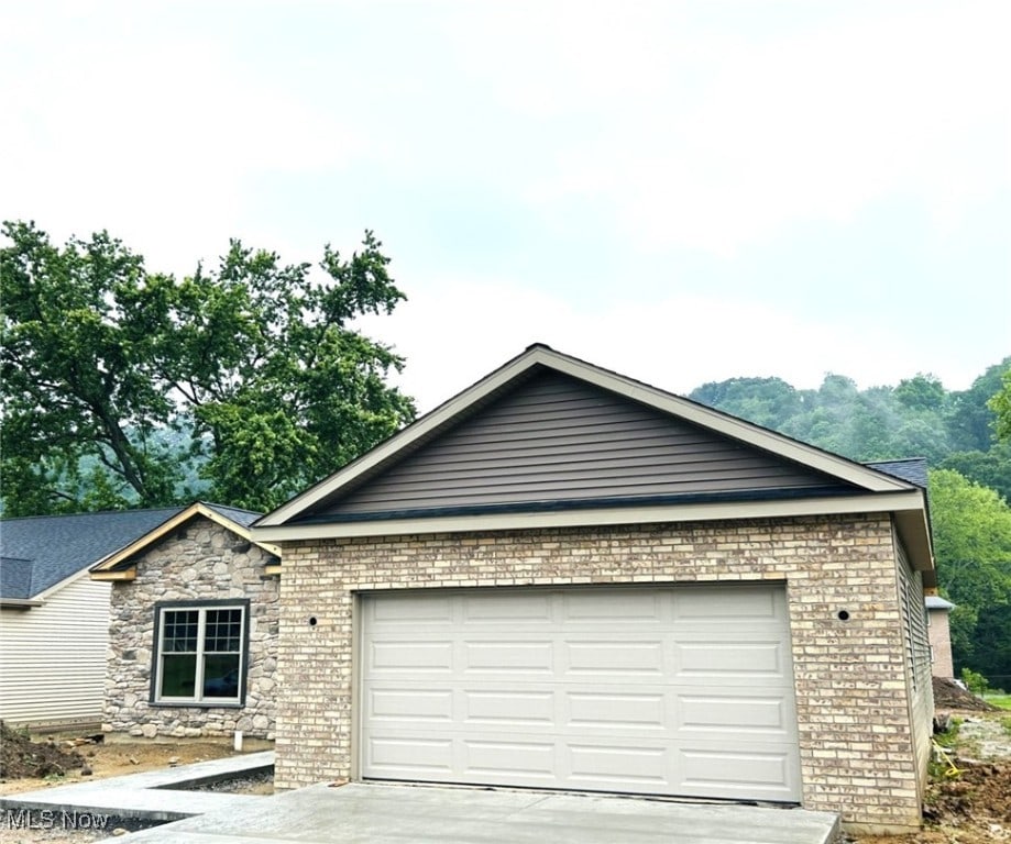 291 Haley Cir, Weirton, WV 26062 - ranch-style house with a garage, concrete driveway, and brick siding