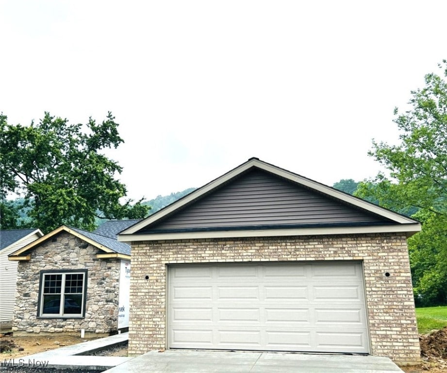 291 Haley Cir, Weirton, WV 26062 - ranch-style house with concrete driveway, an attached garage, and brick siding