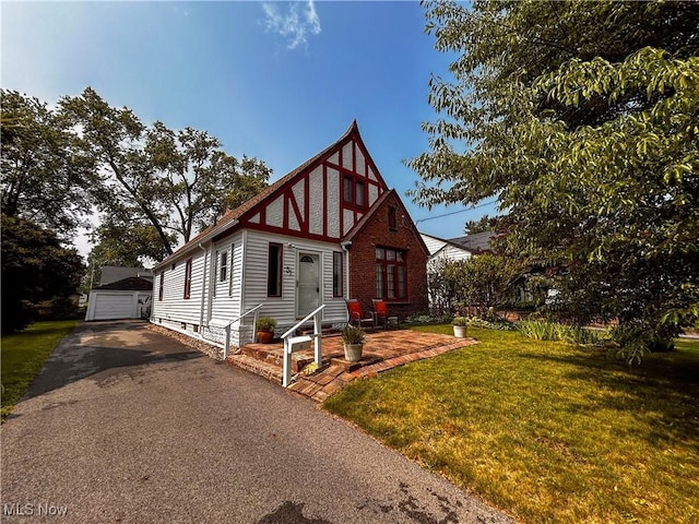 31 Marlindale Ave, Boardman, OH 44512 - english style home with a garage, a front lawn, and an outbuilding