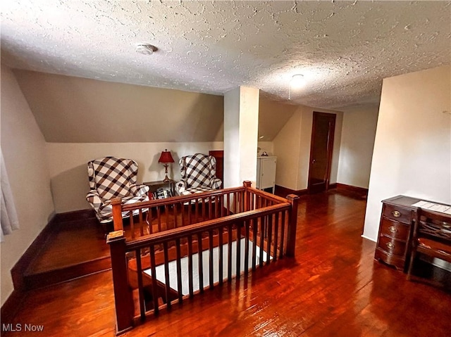 31 Marlindale Ave, Boardman, OH 44512 - hallway with an upstairs landing, hardwood / wood-style flooring, a textured ceiling, baseboards, and washer / dryer