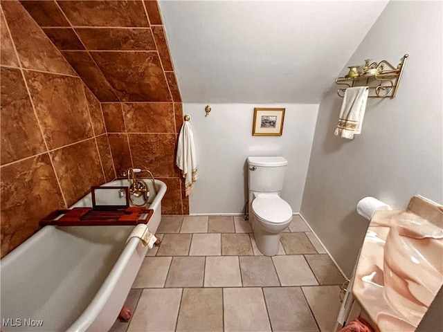 31 Marlindale Ave, Boardman, OH 44512 - bathroom with a bath, toilet, vaulted ceiling, and tile patterned flooring