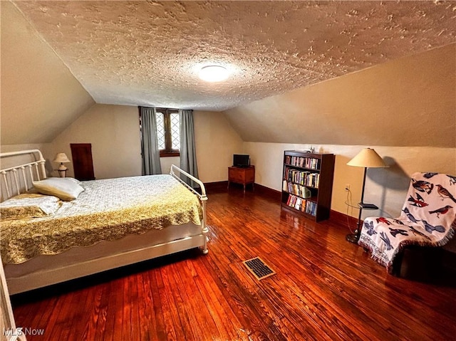 31 Marlindale Ave, Boardman, OH 44512 - bedroom with hardwood / wood-style flooring, lofted ceiling, a textured ceiling, and baseboards