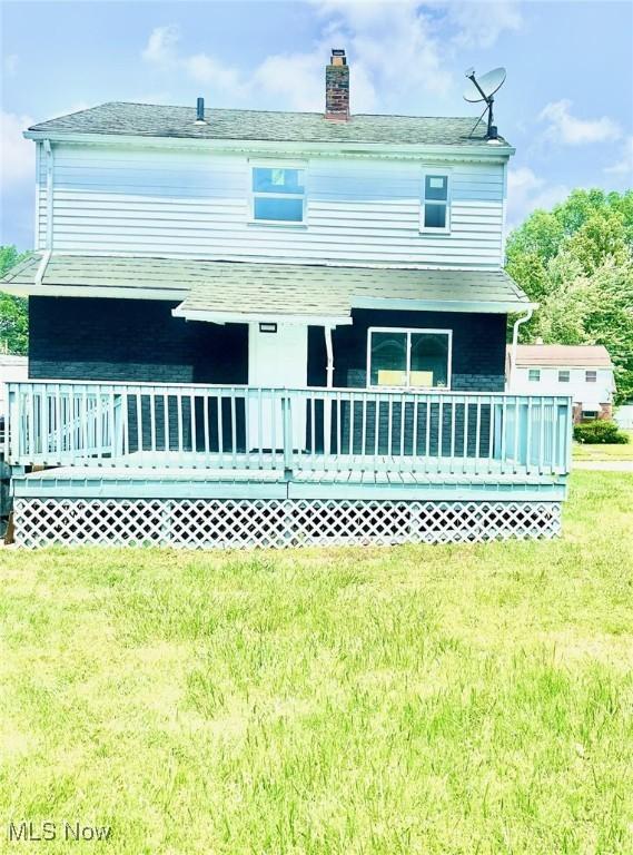 1389 Diagonal Rd, Akron, OH 44320 - back of house with a lawn, a chimney, and a porch