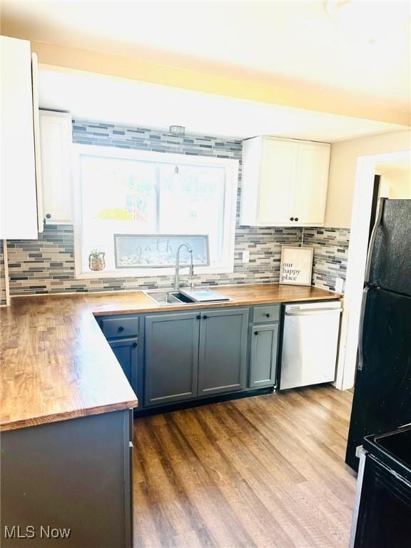 1389 Diagonal Rd, Akron, OH 44320 - kitchen with a sink, black appliances, tasteful backsplash, and wood finished floors