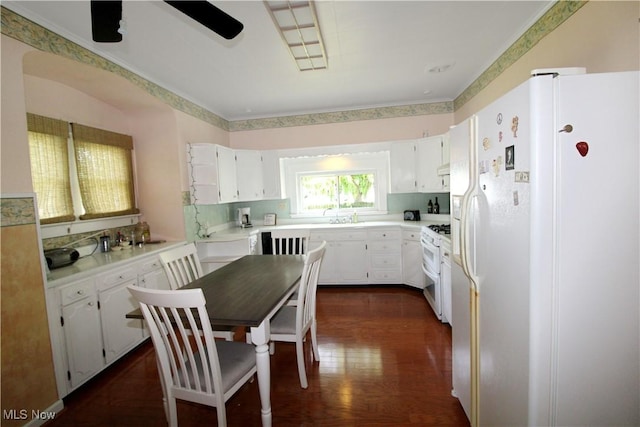 1201 E 3rd St, Port Clinton, OH 43452 - kitchen featuring white fridge with ice dispenser, double oven range, white cabinetry, dark wood-type flooring, and light countertops