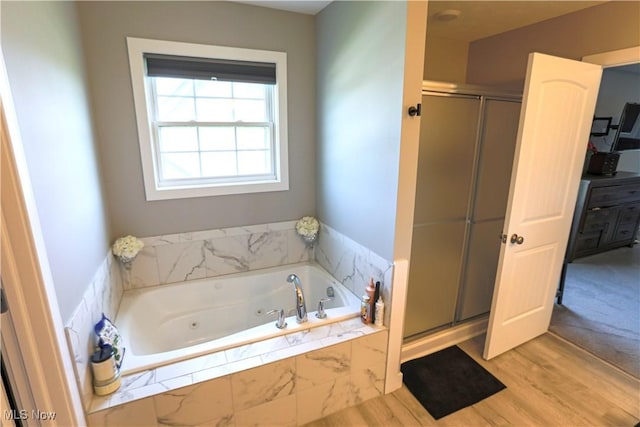 8224 Lilly Ln, Concord, OH 44077 - bathroom with a stall shower, a jetted tub, and wood finished floors