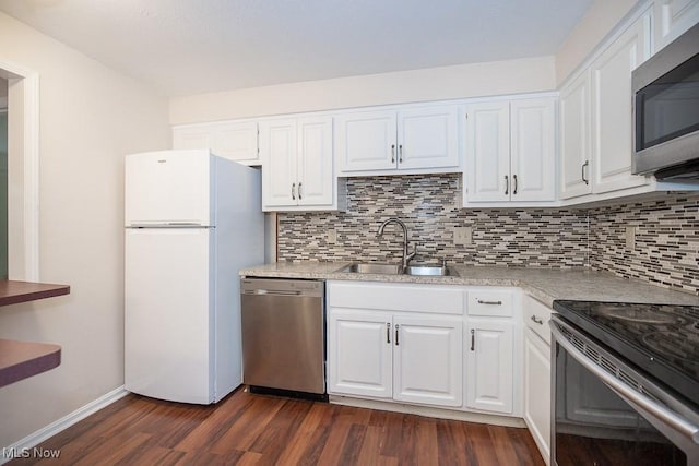 800 Brick Mill Run Unit 103, Westlake, OH 44145 - kitchen featuring appliances with stainless steel finishes, a sink, dark wood-style flooring, and white cabinets