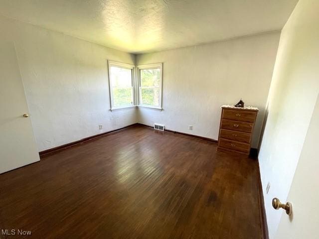 48555 Calcutta Smithferry Rd, East Liverpool, OH 43920 - unfurnished bedroom featuring dark wood-style flooring and baseboards