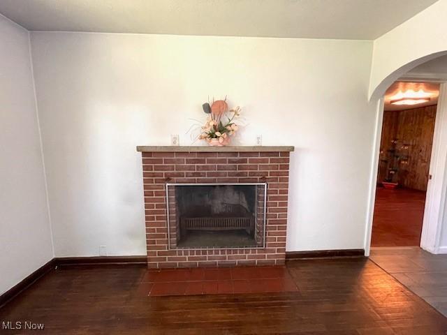 48555 Calcutta Smithferry Rd, East Liverpool, OH 43920 - detailed view of wood finished floors, a fireplace with flush hearth, arched walkways, and baseboards