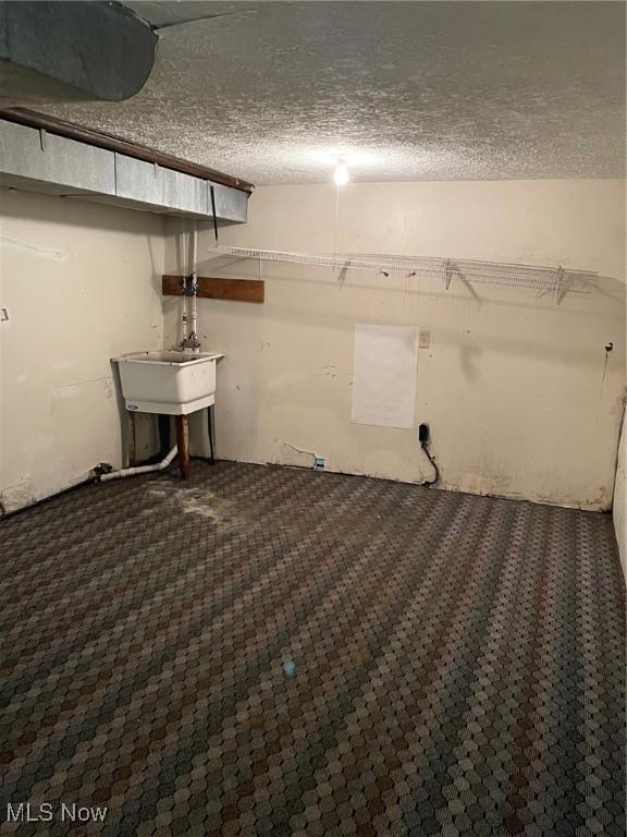 772 Shoshone Ave, Akron, OH 44305 - basement with a textured ceiling and a sink
