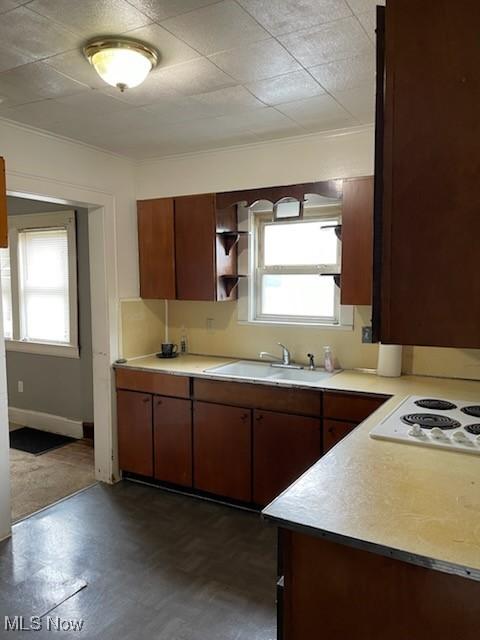 772 Shoshone Ave, Akron, OH 44305 - kitchen with white electric stovetop, light countertops, open shelves, and crown molding