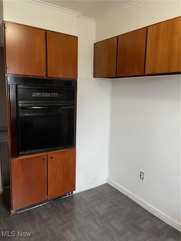 772 Shoshone Ave, Akron, OH 44305 - kitchen with oven, brown cabinetry, and crown molding