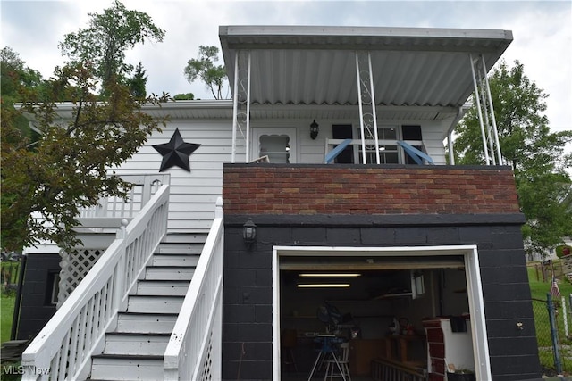1408 N 9th St, Martins Ferry, OH 43935 - rear view of property with stairway and an attached garage